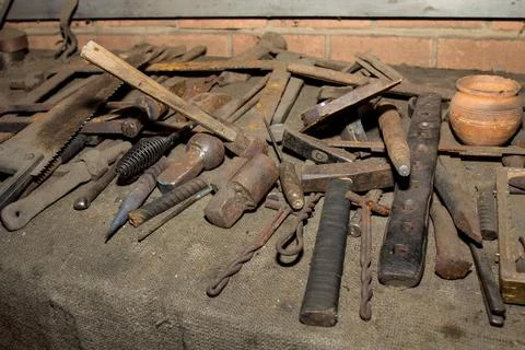 Blacksmith's working tools on table. Forge master Stock Photos