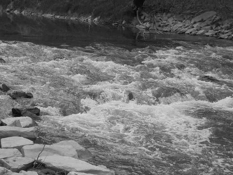 Blackwhite image - Close view of rapids on large river with foam and rocky Stock Photos