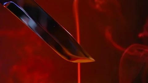 Blade of a knife close-up on a red background. Steel arms, Dagger. Blade clos Stock Footage 93046222