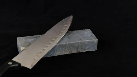 Blade sharpening close-up, a man is sharpening a knife, Stock Footage 93773252