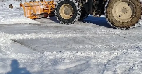 A blade tractor pushes the snow off the road Stock Footage 169335617