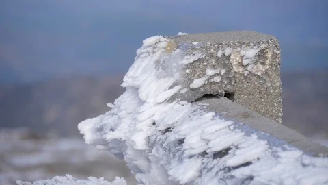 Blades of ice formed by wind in road rail 4k Stock Footage 85902273