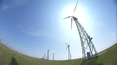 Blades of a wind electro-turbine while working on the background of the sun Stock Footage 109470238