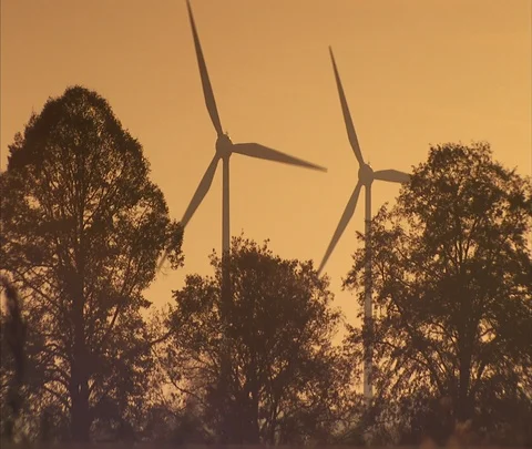 Blades of wind turbines turning over tree tops. Stock Footage 86743138