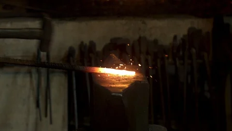 Bladesmith and blacksmith work on knives and metal in old anvil in slowmotion Stock Footage 96350262