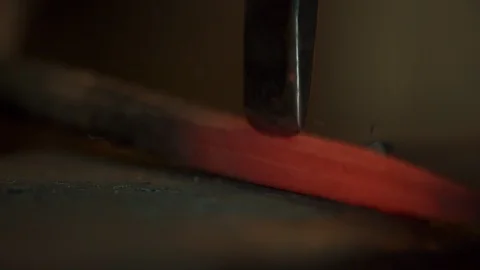 Bladesmith and blacksmith work on knives and metal in old anvil in slowmotion Stock Footage 96350516