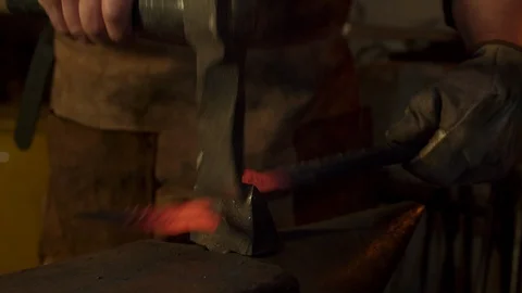 Bladesmith and blacksmith work on knives and metal in old anvil in slowmotion Stock Footage 96351439