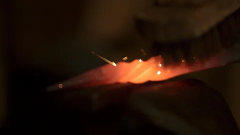 Bladesmith and blacksmith work on knives and metal in old anvil in slowmotion Stock Footage 96352699