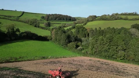 Blagdon, South Devon, England: DRONE VIEWS: Mechanised plough machine in action Stock Footage 252586853