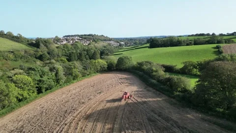 Blagdon, South Devon, England: DRONE VIEWS: Mechanised plough machine in action Stock Footage 252586911