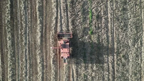 Blagdon, South Devon, England: DRONE VIEWS: A mechanised plough furrows a field Stock Footage 252586949