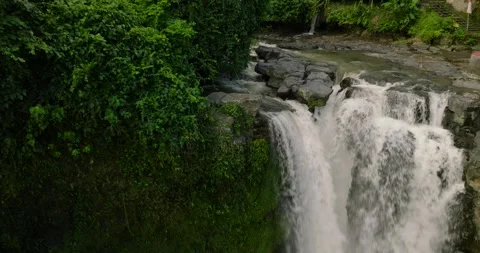 Blangsinga waterfall, Bali. Aerial view of a lush waterfall in a forest Stock Footage 276089913