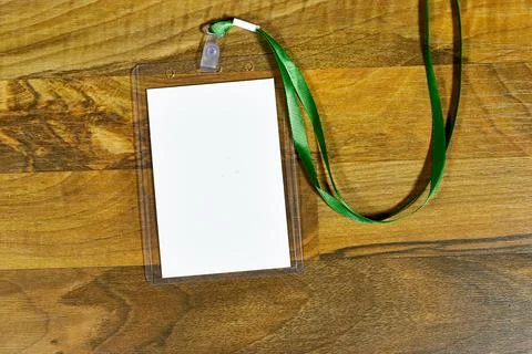 Blank badge mockup. Plain empty name tag mock up on wood table. Name tag with gr Stock Photos