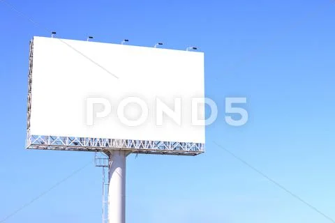 Blank billboard against blue sky for advertisement. Stock Photos