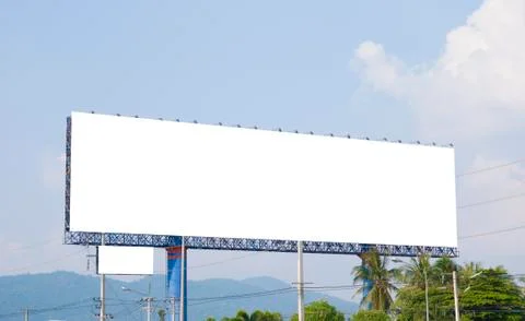 Blank billboard on the building with white space background for advertisement. Stock Photos