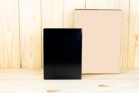 Blank black box and blank brown box on wooden table.Zoom in and vertical Stock Photos
