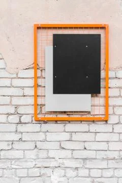 Blank black rectangle in an orange frame on a brick wall. 写真素材