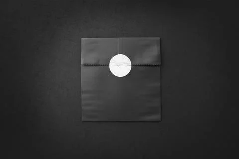 Blank black rectangle paper bag with sticker mockup, dark background Stock Photos