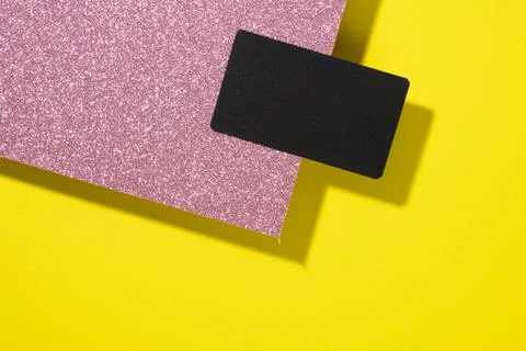 Blank black rectangular business card on a creative background from sheets of Stock Photos