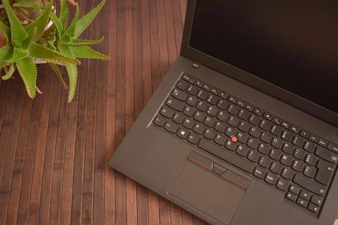 Blank black screen of laptop computer on desk in brown background Stock Photos