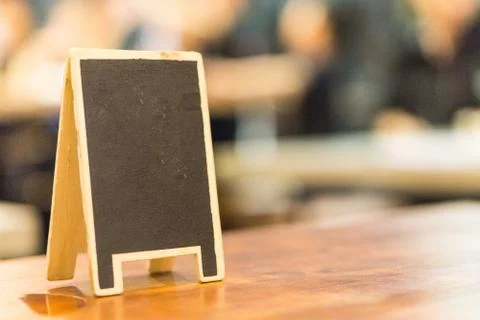 Blank board on the table., in restaurant with copy space for text. coffee sho Stock Photos