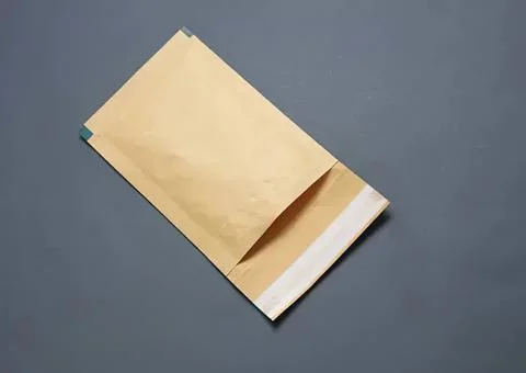 Blank brown envelope on gray background Stock Photos