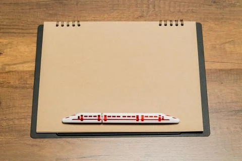 Blank brown paper sheet with train shape pen Stock Photos