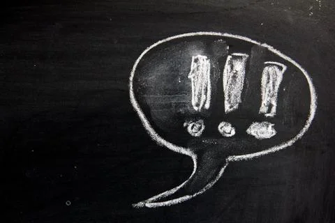 Blank bubble speec as comic dialog on blackboard background Stock Photos