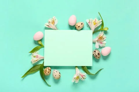 Blank card with Easter eggs, alstroemeria flowers on turquoise background Stock Photos