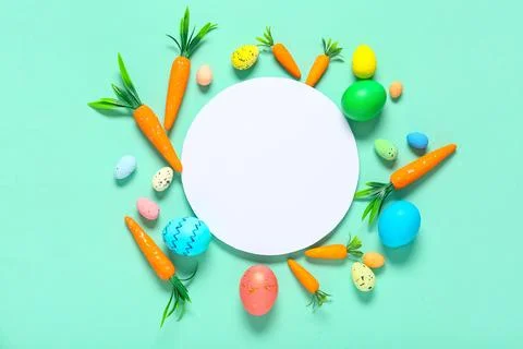 Blank card with Easter eggs and decorative carrots on turquoise background Stock Photos
