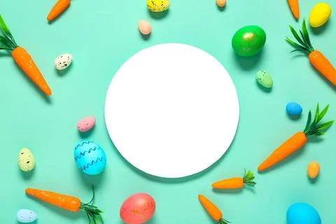 Blank card with Easter eggs and decorative carrots on turquoise background Stock Photos