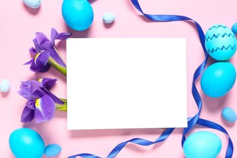 Blank card with Easter eggs, iris flowers and ribbon on pink background Stock Photos