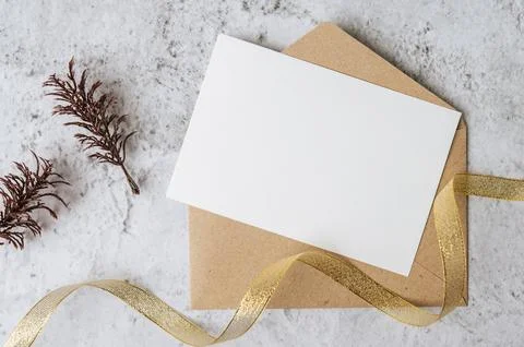 A blank card with envelope and leaf is placed on white background Stock Photos
