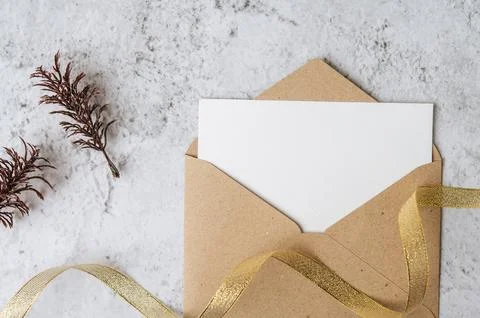 A blank card with envelope and leaf is placed on white background Stock Photos