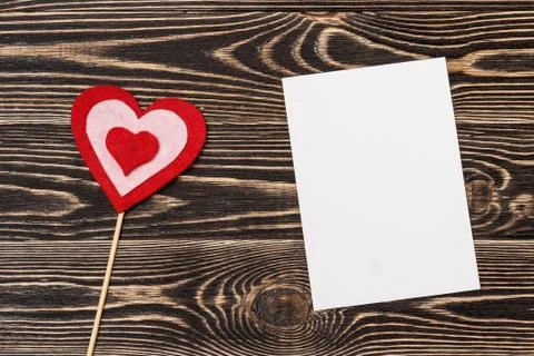 Blank card with heart on wooden background Stock Photos