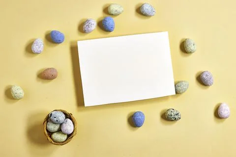 Blank Card With Pastel Speckled Easter Eggs Flat Lay on Yellow Background for Sp Stock Photos