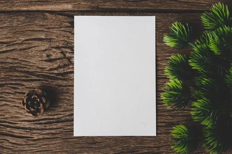 A blank card is placed on envelope and leaf with wood background Stock Photos