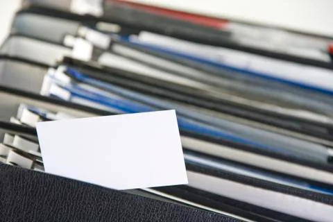 Blank card on stack of binders Stock Photos