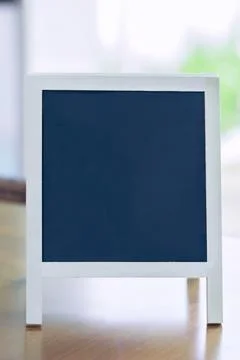 Blank Chalkboard on Table for Creative Mockups Stock Photos