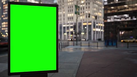 Blank chroma key billboard on a city street at sunset, traffic timelapse Stock Footage 345501009