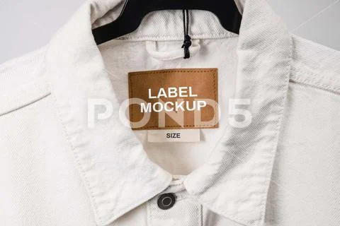 Blank clothing label on denim jacket texture. Label with empty space for text PSD Template