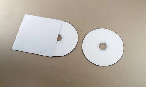Blank compact disk Blank compact disk on a table. Mock-up for branding ide... Stock Photos