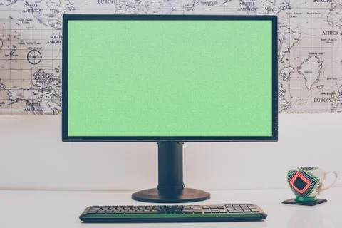 Blank computer desktop with keyboard and coffee mug on white table in sunny r Stock Photos