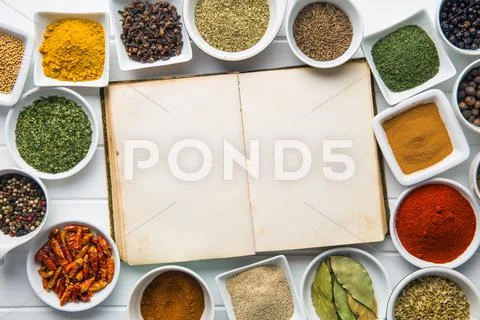 Blank cookbook and various spices. Stock Photos