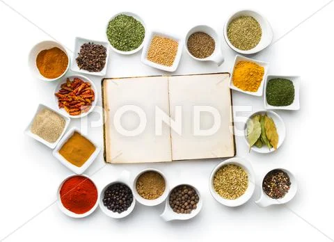 Blank cookbook and various spices. Stock Photos