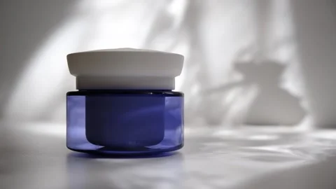 Blank cream container, blue and white, sunlight. Podium, Stock Footage 291593274