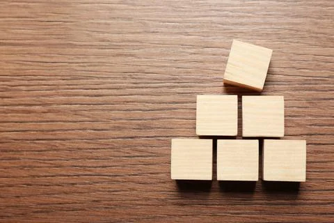 Blank cubes on wooden table, flat lay with space for text. Idea concept Stock Photos