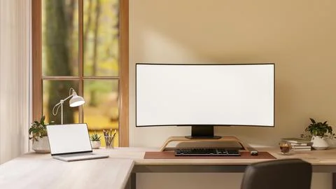Blank curved screen computer with laptop and lamp on wooden table in living.. イラスト素材