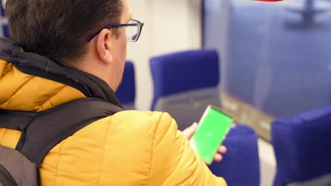 Blank digital phone in hand of guy standing indoors in public transport Stock Footage 169278518