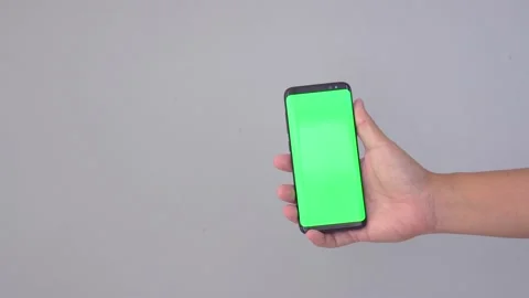 Blank digital smartphone in hand of men, Mobile phone green screen Stock Footage 147870969